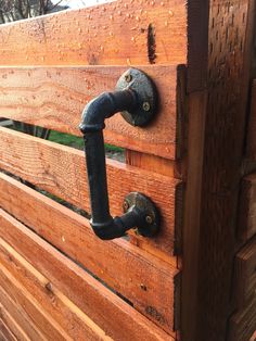 a wooden bench with an iron handle on it's latch and some wood planks