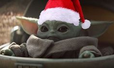 a baby yoda wearing a santa hat