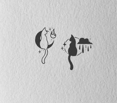 two cats that are sitting next to each other on some paper with water drops coming from them