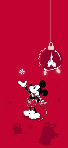 a mickey mouse christmas ornament hanging on a red background with snowflakes