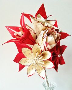 a vase filled with red and white flowers