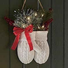 a pair of white socks hanging from a door with christmas lights on the inside and outside