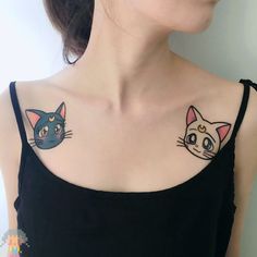 a woman with two cats on her chest and one has a cat tattoo on it