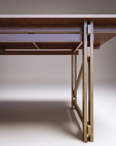 a wooden desk with two legs and a table top on the bottom, against a white background