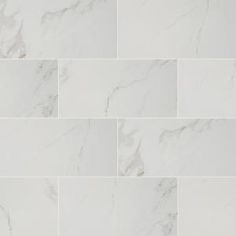 a white marble tile wall that looks like it has been cleaned