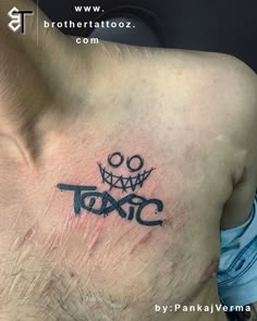 a man with a tattoo on his chest has the word tac written in black ink