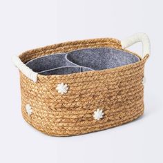 the basket is made out of jute and has two compartments with handles for storage