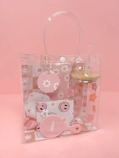 a clear plastic bag with pink and white flowers on the inside, along with other items