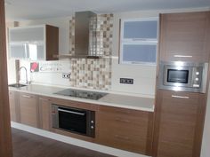 a kitchen with wooden cabinets and stainless steel appliances