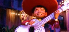 a man in a sombrero playing an acoustic guitar