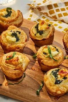 there are many small pastries on the cutting board