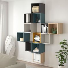 a living room filled with furniture next to a white wall covered in bookshelves