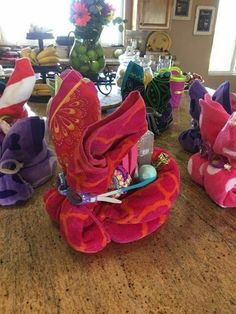 several stuffed animals sitting on top of a wooden table