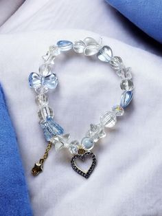 Introducing our exquisite Adorable Crystal Heart Charm Beaded Bracelet, a stunning piece of jewelry that beautifully combines elegance and charm. This bracelet features a mesmerizing blue crystal heart, perfectly complemented by an array of dazzling crystal beads and delicate bead charms. Crafted to fit comfortably at approximately 7.5 inches, this stretch bracelet is designed to add a touch of sophistication to any outfit. It's the ideal gift for mom or a unique present for someone special who Charm Bracelet Beaded, Charm Bracelet Aesthetic, Bracelet Aesthetic, Charm Beaded Bracelet, Lake Havasu City, Lake Havasu, Gold Charm Bracelet, Bracelet Charms, Bead Charm Bracelet