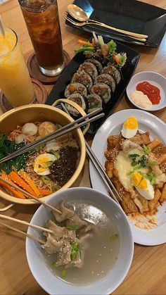 a table topped with plates of food and chopsticks