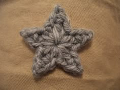 a crocheted star ornament is shown on the back of a sweater