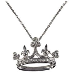 Vintage 14 Karat White Gold and Diamond Crown Pendant Necklace- This lovely crown pendant features 22 round brilliant cut diamonds set in classic 14K white gold. Suspends from a classic 14K white gold chain. Approximate total diamond weight: .25 ct. Diamond color: H-I Diamond clarity: SI1-I1 Size: 18 mm x 25 mm (pendant) 16.5 inches (necklace) Weight: 3.2 dwt. / 5.1 gr. Tested for 14K gold. Very good condition, professionally polished. Will come packaged in a gift box or pouch (when possible) and will be shipped U.S. Priority Mail Insured. DV013023/17KCS Crown Pendant Necklace, Crown Pendant, White Gold Chain, Diamond Crown, Round Brilliant Cut Diamond, Diamond Clarity, Brilliant Cut Diamond, White Gold Diamonds, Round Brilliant