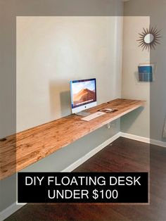 a desk with a computer on it and the words diy floating desk under $ 100