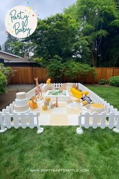 an outdoor play area with toys and decorations for a baby's first birthday party