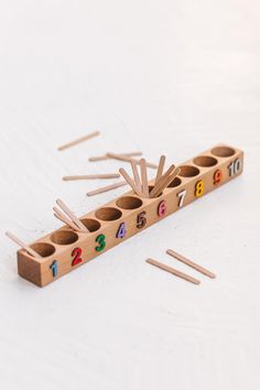 a wooden matchstick holder with numbers on it