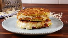 a grilled cheese sandwich sitting on top of a plate next to a grater