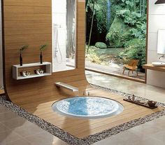 a bath room with a large window and a jacuzzi tub inside of it