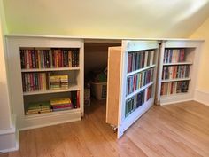 an open bookcase in the corner of a room with hard wood floors and white walls