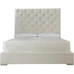 a white bed with an upholstered headboard and foot board on the side