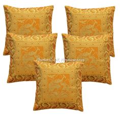 four orange and gold pillows with an animal design on the front, one in yellow