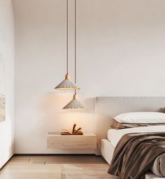 a bedroom with a bed, nightstand and hanging lamp in the corner next to it