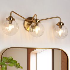 a bathroom vanity with two lights and a mirror