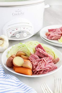 two white plates filled with meat and vegetables next to an instant pressure cooker pot