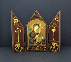 an ornate wooden icon depicting the virgin mary and child jesus