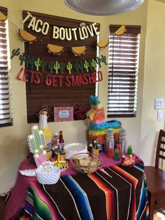 a table covered with food and decorations for a mexican themed birthday party or baby shower