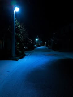 an empty street at night with blue lights