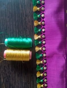 two spools of thread sitting next to each other on top of a table