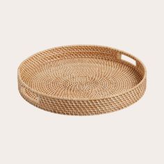 an oval rattan tray with handles