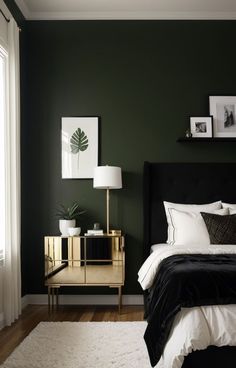 a bedroom with dark green walls, white bedding and gold nightstands in the corner