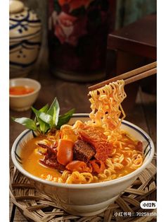 a bowl of ramen with chopsticks sticking out of the noodles and meat