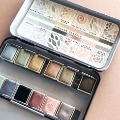 the eyeshadow palettes are in an open tin