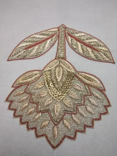 an embroidered piece with gold and red details