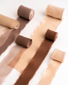 several rolls of brown and tan colored fabric