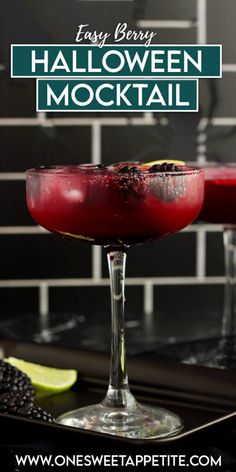 the easy berry halloween mocko cocktail is ready to be served with lime wedges