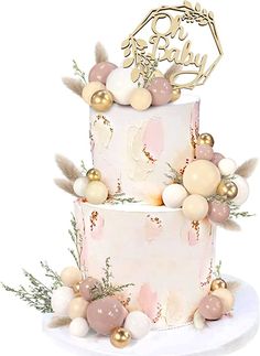 a pink and white cake with gold decorations