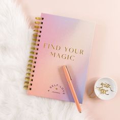 a pink notebook with the words find your magic on it