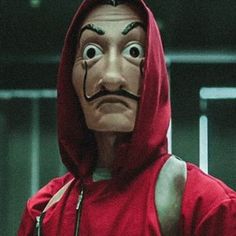 a man in a red hoodie with a face painted like a moustache