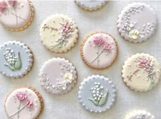 nine decorated cookies with flowers on them