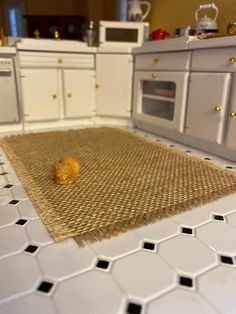 a close up of a kitchen floor with a rug on it