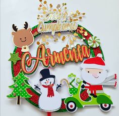 a christmas wreath with santa claus, snowman and reindeer on the front surrounded by holiday decorations