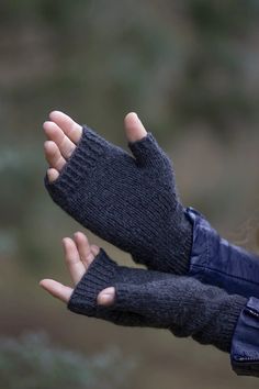 a woman's hand wearing a pair of black gloves